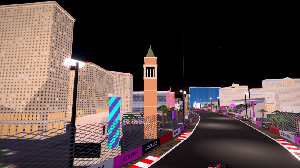 The Venetian's brick bell tower with its green spire among the lit hotel towers, the track curving past